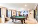 Spacious game room equipped with a pool table, arcade games, and Star Wars-themed wall art at 7219 Oakmoss Loop, Davenport, FL 33837