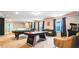 This game room has activities for all ages, featuring a pool table, ping pong table, and retro video game at 7219 Oakmoss Loop, Davenport, FL 33837