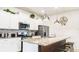 Well-equipped kitchen features granite countertops, modern appliances, and a spacious island with seating at 7219 Oakmoss Loop, Davenport, FL 33837