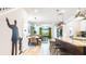 Open-concept kitchen overlooking the dining and living areas, ideal for gatherings at 7219 Oakmoss Loop, Davenport, FL 33837
