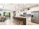 Open concept kitchen with granite counters, stainless steel appliances, and a center island at 7219 Oakmoss Loop, Davenport, FL 33837