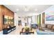 Spacious living room featuring wood accent wall, tile floors, and an open floor plan into the kitchen at 7219 Oakmoss Loop, Davenport, FL 33837