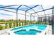Beautiful screened-in pool overlooking a serene lake with manicured landscaping at 7219 Oakmoss Loop, Davenport, FL 33837