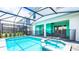 Gorgeous pool with a connected spa and a screened-in patio area at 7219 Oakmoss Loop, Davenport, FL 33837