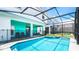 Stunning pool featuring a connected spa, outdoor seating, and a screened-in enclosure at 7219 Oakmoss Loop, Davenport, FL 33837