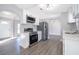 Modern kitchen featuring stainless steel appliances, white cabinetry, and stylish lighting at 738 Paris Dr, Kissimmee, FL 34759