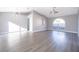 Bright living room showcasing the vaulted ceilings, an arched window and modern gray vinyl plank flooring at 738 Paris Dr, Kissimmee, FL 34759