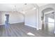 Open-concept living room featuring modern lighting, arched doorways, and stylish laminate flooring at 738 Paris Dr, Kissimmee, FL 34759