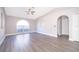 Spacious living room with a vaulted ceiling, large window and modern gray vinyl plank flooring at 738 Paris Dr, Kissimmee, FL 34759
