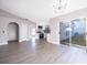 Open-concept living space featuring luxury vinyl plank flooring, modern lighting and a bright kitchen at 738 Paris Dr, Kissimmee, FL 34759
