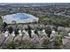 Aerial view of a neighborhood featuring homes with private pools and manicured lawns near a lake at 7709 Comrow St, Kissimmee, FL 34747