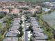 Aerial view of a residential area with community pool, lake, and well-maintained landscaping at 7709 Comrow St, Kissimmee, FL 34747