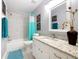 Bathroom with a shower and tub combo, granite vanity and decorative mirror at 7709 Comrow St, Kissimmee, FL 34747