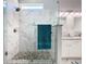 Modern bathroom featuring a glass shower with pebble flooring and a double sink vanity with marble countertops at 7709 Comrow St, Kissimmee, FL 34747