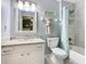 Beautiful bathroom featuring a granite vanity top, shower, and updated mirror at 7709 Comrow St, Kissimmee, FL 34747