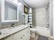 Updated bathroom with a large vanity, tub with tiled wall, and updated fixtures at 7709 Comrow St, Kissimmee, FL 34747