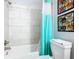 Bright bathroom featuring a shower/tub combo with white subway tile and decorative accents at 7709 Comrow St, Kissimmee, FL 34747