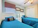 Bright bedroom showcasing twin beds with white headboards and a cozy window seat at 7709 Comrow St, Kissimmee, FL 34747
