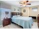 Comfortable bedroom features a ceiling fan, natural light, and a calming, neutral color palette at 7709 Comrow St, Kissimmee, FL 34747