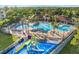 An aerial view showcases a resort-style pool, area, and inviting amenities for community enjoyment at 7709 Comrow St, Kissimmee, FL 34747