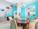 Dining room with a staircase, white railing, and decorative furniture at 7709 Comrow St, Kissimmee, FL 34747