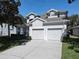 Charming two-story home featuring a two-car garage, well-maintained landscaping, and a welcoming facade at 7709 Comrow St, Kissimmee, FL 34747