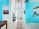 Bright foyer with a hallway and front door featuring a decorative rug at 7709 Comrow St, Kissimmee, FL 34747