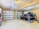 Spacious garage with three doors, a ping pong table, and overhead lighting at 7709 Comrow St, Kissimmee, FL 34747