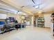 Three car garage with epoxy flooring, a ping pong table, and a laundry area at 7709 Comrow St, Kissimmee, FL 34747