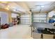 Spacious three car garage with a ceiling fan, ping pong table, and ample storage space at 7709 Comrow St, Kissimmee, FL 34747