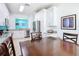 Bright kitchen with stainless steel appliances, granite countertops, and white cabinetry, as seen from dining area at 7709 Comrow St, Kissimmee, FL 34747