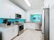 Well-lit kitchen with stainless steel appliances, granite countertops, and white cabinetry at 7709 Comrow St, Kissimmee, FL 34747