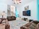 Spacious living room featuring leather sofas, a ceiling fan, and a decorative rug at 7709 Comrow St, Kissimmee, FL 34747