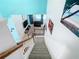 An overhead view from stairs showing the living room and access to outdoor pool area at 7709 Comrow St, Kissimmee, FL 34747