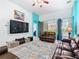 Inviting living room featuring leather seating, a large TV, and poolside views at 7709 Comrow St, Kissimmee, FL 34747