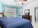 Cozy main bedroom featuring natural light, a view of the backyard, and an updated dresser at 7709 Comrow St, Kissimmee, FL 34747