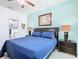 Comfortable main bedroom featuring modern furniture, blue walls, and a full bed at 7709 Comrow St, Kissimmee, FL 34747