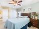 Comfortable bedroom featuring a full bed, a closet, and updated ceiling fan and bedside tables at 7709 Comrow St, Kissimmee, FL 34747