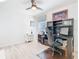 Well-lit office with ceiling fan, desk, computer setup, and light laminate flooring at 7709 Comrow St, Kissimmee, FL 34747