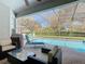 Relaxing patio with comfortable seating and a view of the screened pool area at 7709 Comrow St, Kissimmee, FL 34747