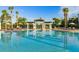 Resort-style pool featuring pergolas, mature palms, and comfortable lounge seating at 7709 Comrow St, Kissimmee, FL 34747