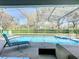 Covered lanai featuring a sparkling pool and a jacuzzi tub with a screened enclosure and brick pavers at 7709 Comrow St, Kissimmee, FL 34747