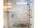 The glass shower features marble-look tile, a pebble floor, and a built-in soap niche at 7709 Comrow St, Kissimmee, FL 34747