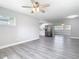 Bright living room featuring gray flooring, ceiling fan, and view into the modern kitchen at 815 Agnes Dr, Altamonte Springs, FL 32701