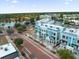 Aerial view of colorful townhomes, beautiful streetscapes, and a nearby lake at 871 City Walk Ln # B-1, Oviedo, FL 32765