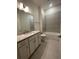 Bathroom featuring granite countertop vanity, modern fixtures, and tiled shower-tub combo at 871 City Walk Ln # B-1, Oviedo, FL 32765