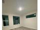 This bedroom has hard wood floors and three windows for natural light at 871 City Walk Ln # B-1, Oviedo, FL 32765