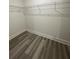 View of an empty closet with metal shelving and wood-look floors at 871 City Walk Ln # B-1, Oviedo, FL 32765