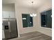 Dining area with modern light fixture and large windows at 871 City Walk Ln # B-1, Oviedo, FL 32765