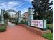 Welcoming entrance sign for Oviedo on the Park with lush landscaping and a brick walkway at 871 City Walk Ln # B-1, Oviedo, FL 32765